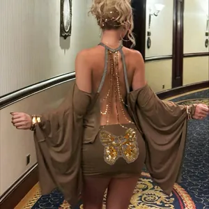 Detail of a sexy backless bodycon dress with batwing sleeves and butterfly sequin