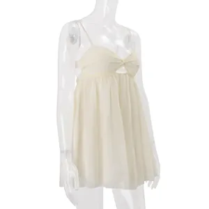 Side view detail of a cream white chiffon spaghetti strap camisole on a clear mannequin