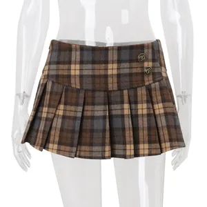 Macro view of vintage brown plaid pleated mini skirt showing metal button details