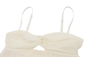 Macro view showing the pleated chiffon texture and twisted bust detail of a white camisole
