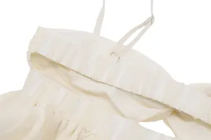 Close-up detail of cream chiffon strappy top showing elasticated ruffled band and stitching
