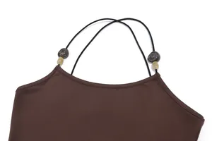 Detailed view of women's brown camisole jumpsuit featuring marbled beads on thin straps