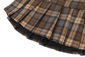 Close-up detail of vintage brown plaid pleated skirt with built-in black safety shorts lining