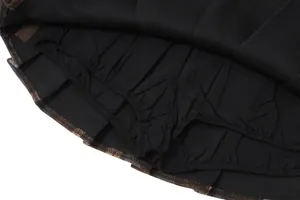 Detailed view of the black inner safety shorts lining of a retro plaid pleated mini skirt