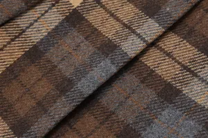 Macro detail of vintage plaid woolen fabric texture in brown and grey tones for skirt