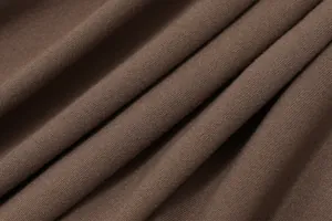 Detailed macro view of soft brown jersey knit fabric texture for summer backless dress