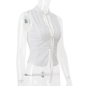 Detailed side view of white lace embroidered tie-front crop top on clear mannequin