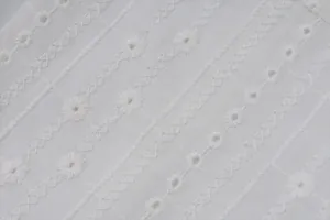 Detailed close-up of white broderie anglaise embroidery on a summer sleeveless vest top