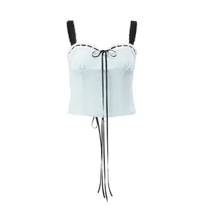 Macro view of light blue summer camisole featuring black lace straps and front bow detail