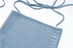 Close-up of glitter blue halter neck camisole showing shimmering fabric texture and straps