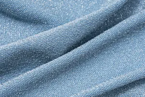 Close-up macro detail of blue shimmer fabric with elegant silver glitter texture finish