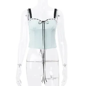 Detailed front view of a light blue corset top with black lace trim and ribbon ties
