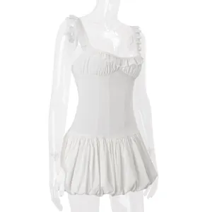 Detailed side view showing ruffles and pleated puff hem of an elegant white mini dress