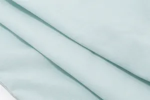 Macro view of light blue fabric texture with fine diagonal weave for summer camisole