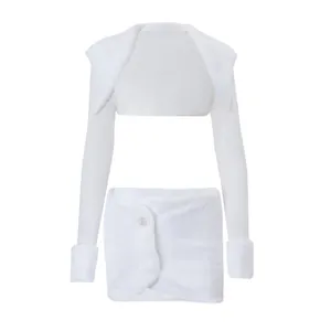 Detailed view of the white faux fur long sleeve shrug and mini skirt set