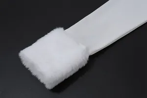 Close-up detail of white faux fur cuff on a minimalist long-sleeved sleeve.