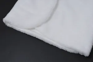 Close-up detail showing the soft and fluffy white faux fur texture of a plush shawl garment