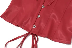 Détail d'un haut corset rouge avec agrafes métalliques et laçage à la base