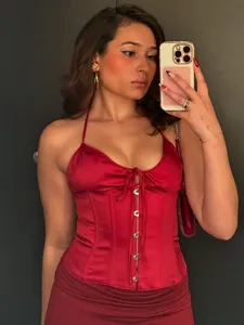 Chic red satin halter corset top with front hook closures and tie-up drawstring detail.