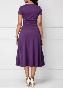 Back view of an elegant purple midi dress with a gathered waist and a flared skirt detail