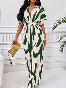 Elegant V-neck batwing sleeve jumpsuit with green and white abstract print detail