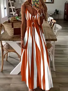 Elegant sleeveless V-neck maxi dress with orange and white striped print in a home setting