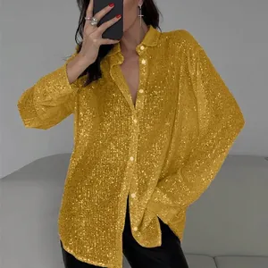 Close-up detail of a glamorous yellow sequined long sleeve blouse with lapel collar