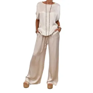 Elegant champagne satin two-piece set featuring a loose short-sleeve blouse and wide-leg pants.