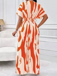 Elegant orange and cream abstract print wide-leg jumpsuit with batwing sleeves.