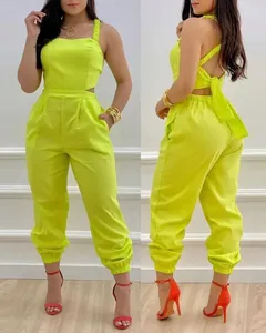 Vibrant neon green backless halter jumpsuit with bow detail and high waist design