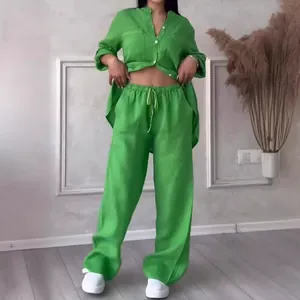 Detailed look at vibrant green linen two-piece set with loose shirt and wide-leg trousers