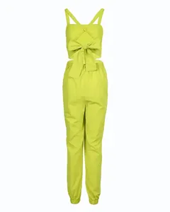 Back view of neon green two-piece set featuring large bow and open back detail