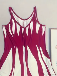 Detail view of the V-neck and abstract burgundy print on sleeveless maxi dress