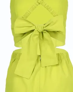 Detail of chartreuse green jumpsuit featuring a large back bow and cut-out design