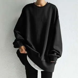 Close-up of black oversized round neck sweatshirt with minimalist textured fabric detail.