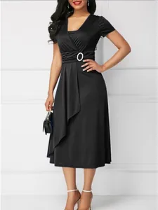 Elegant black V-neck midi dress with asymmetrical skirt and waist buckle detail.