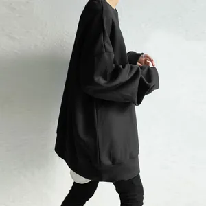 Detailed side view of an oversized black crewneck sweatshirt featuring a loose fit.