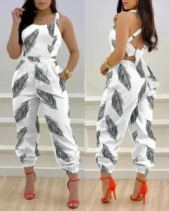 Detailed view of white jumpsuit with black feather print and backless bow tie design.