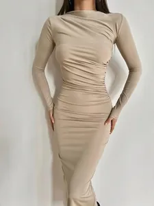 Robe mi-longue froncée à manches longues beige élégante montrant une coupe flatteuse