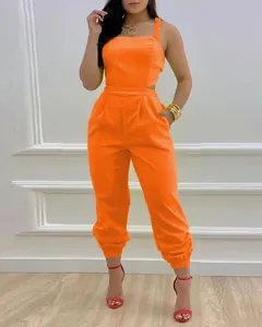 Detailed view of a vibrant orange high-waisted sleeveless jumpsuit for women in a studio