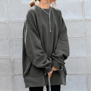Detailed view of oversized dark gray crewneck sweatshirt with dropped shoulders
