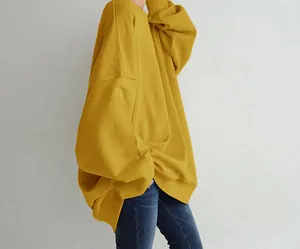 Detail side view showing the loose fit of a mustard yellow crewneck sweatshirt for women
