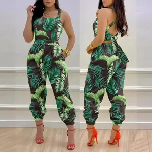 Stylish tropical palm leaf print backless jumpsuit with bow detail and high waist design.