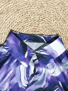 Close-up detail of purple abstract 3D digital print shirt collar and button closure