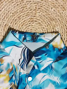 Detailed view of the lapel and 3D digital print on a blue abstract patterned shirt.