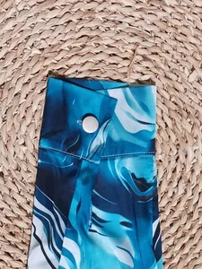 Detailed close-up of a shirt cuff featuring a vibrant blue 3D digital abstract pattern