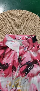 Macro view of button-down collar on vibrant pink 3D digital floral print blouse