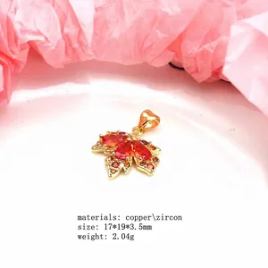 Macro detail of copper maple leaf pendant with red zircon and technical specifications