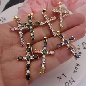 Detail of multi-colored zircon cross pendants in various shades of gold and silver.