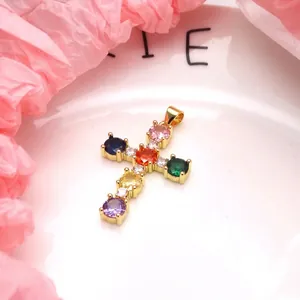 Detailed view of a gold-plated cross pendant featuring vibrant round multi-color zircons